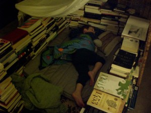 the kiddo sleeps in his fort made of books